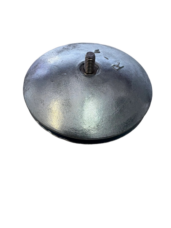 Zinc Anode disc with a central threaded rod on a beige surface